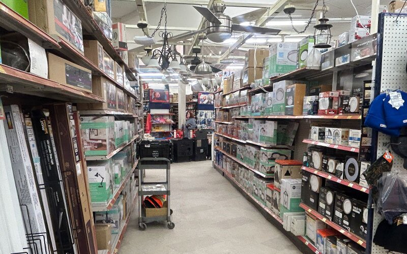 An electrical aisle at Got Wood Building Supplies stocked with products and light fixtures.