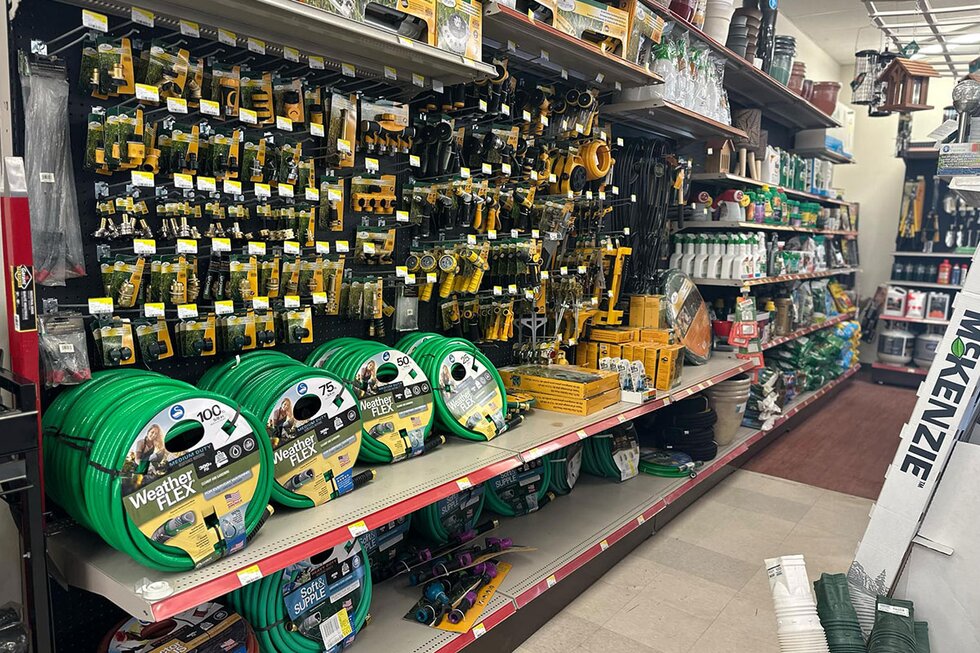 Seasonal aisle of hoses and accessories at Got Wood Building Supplies.