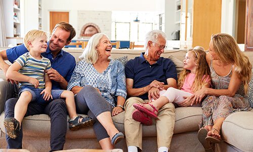 Happy multi-generational family relaxing on the couch.