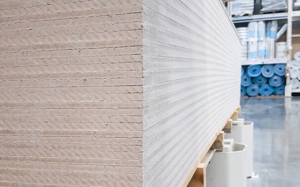 A large, upclose stack of drywall in a store.