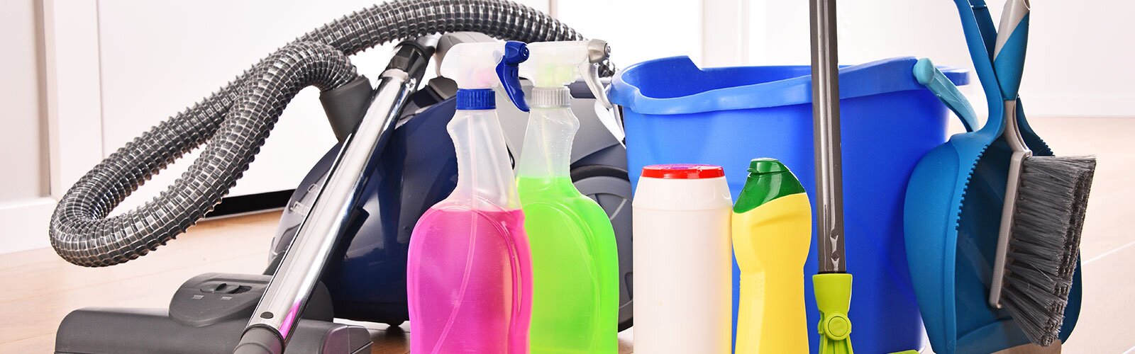 A group of cleaning supplies and a vacuum. 