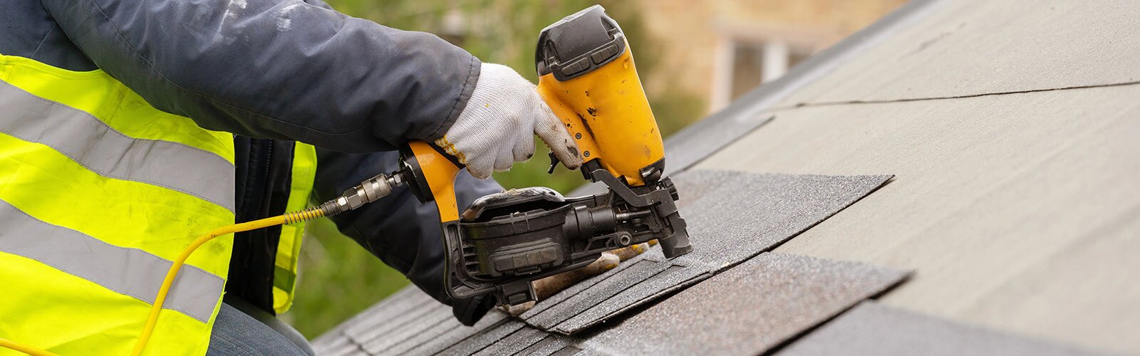 Up close of a roofer installing shingles on a home.