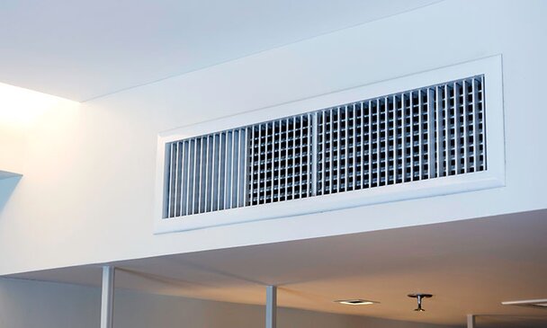 A white, narrow ceiling vent.