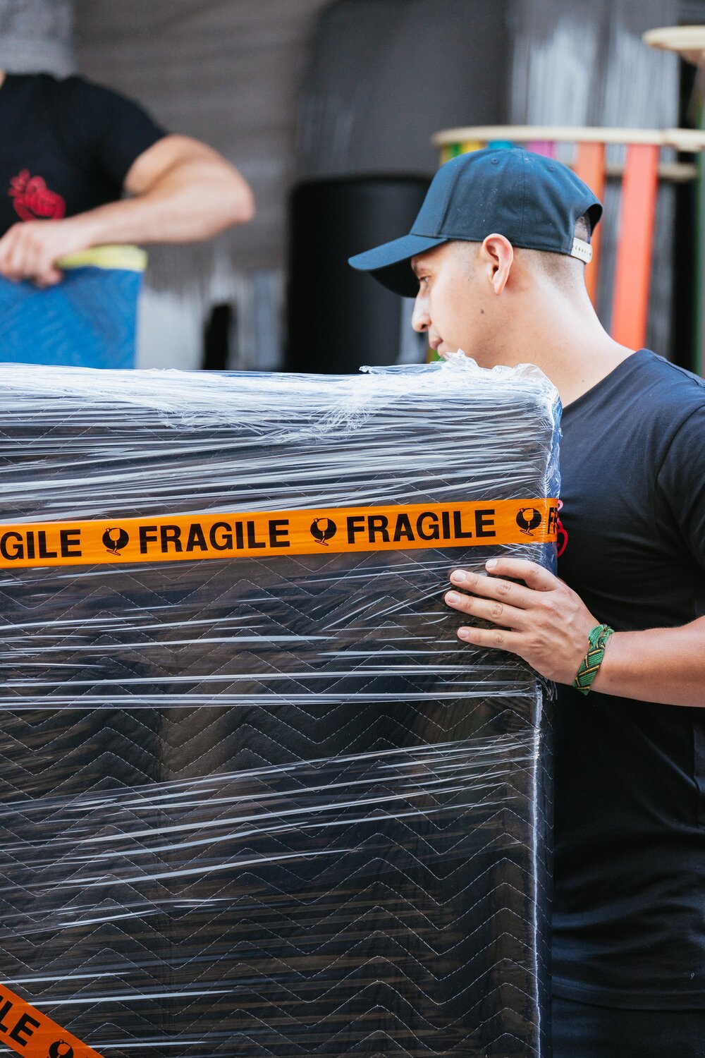Framed artwork loaded upright on edge and strapped against the wall of a removal truck