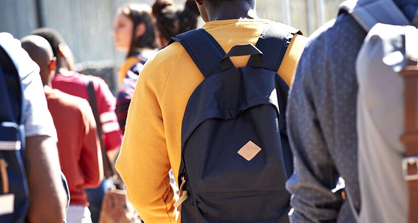 student with backpack walking