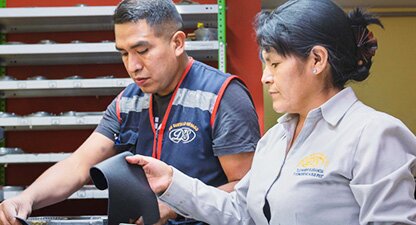 Factory workers examining product