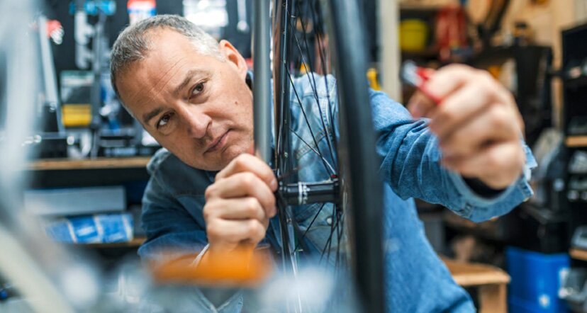 man working on bicycle