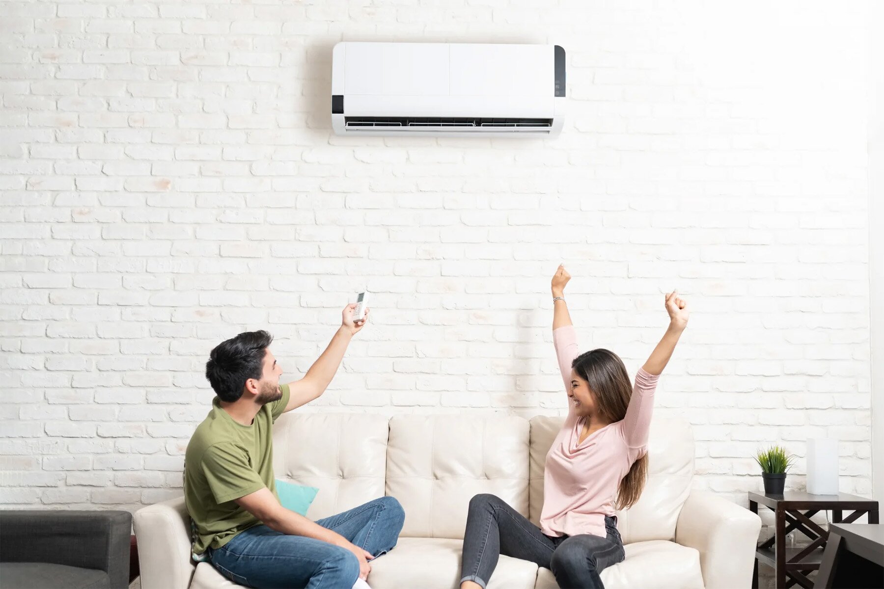 Couple using wall space heater at home