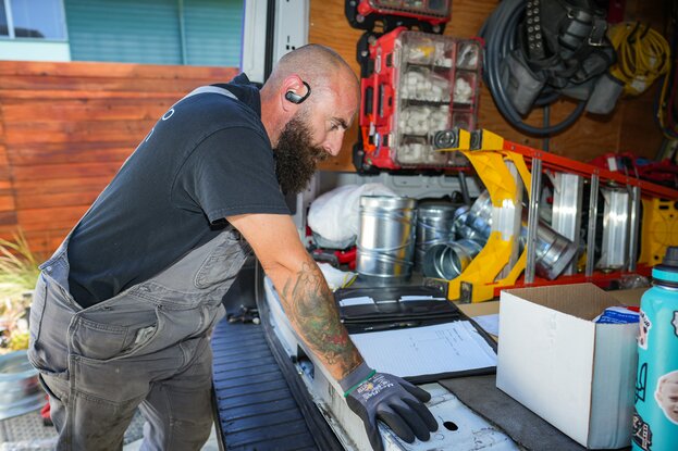 Contractor working on exterior appliance