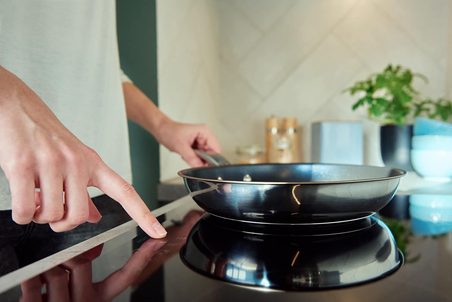 Person testing induction cooking appliance