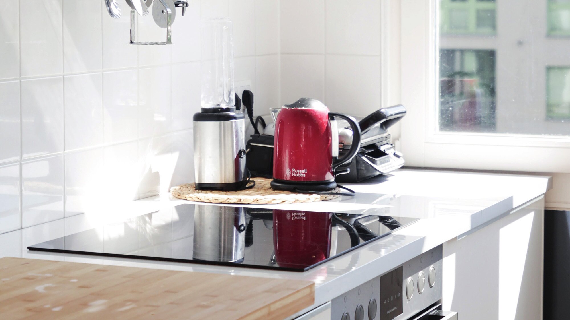 Home kitchen corner with induction cooktop and electric appliances