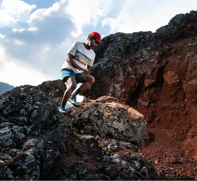 Person hiking on rocky terrain outdoors