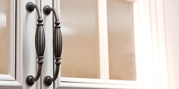 Decorative kitchen cabinet handles doors with frosted glass panels.