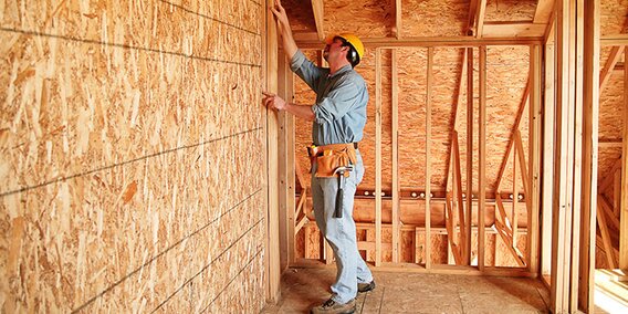A contractor checks the construction of a new building.