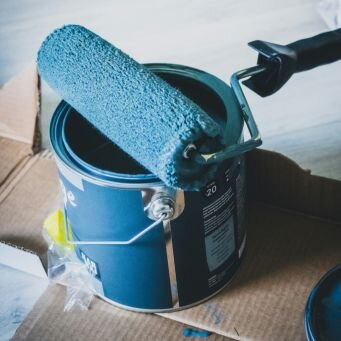 Man painting a wall blue
