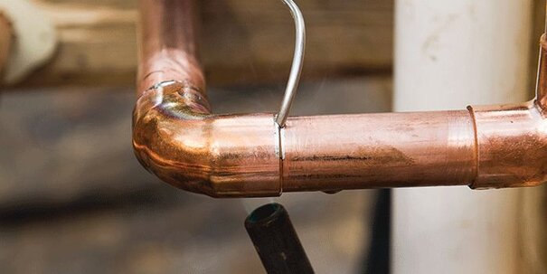 A copper pipe being showed upclose.