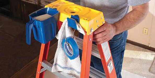 Painting accessories attached to ladder while a DIYer is ready to get painting.