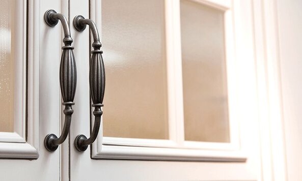 Decorative kitchen cabinet handles doors with frosted glass panels.