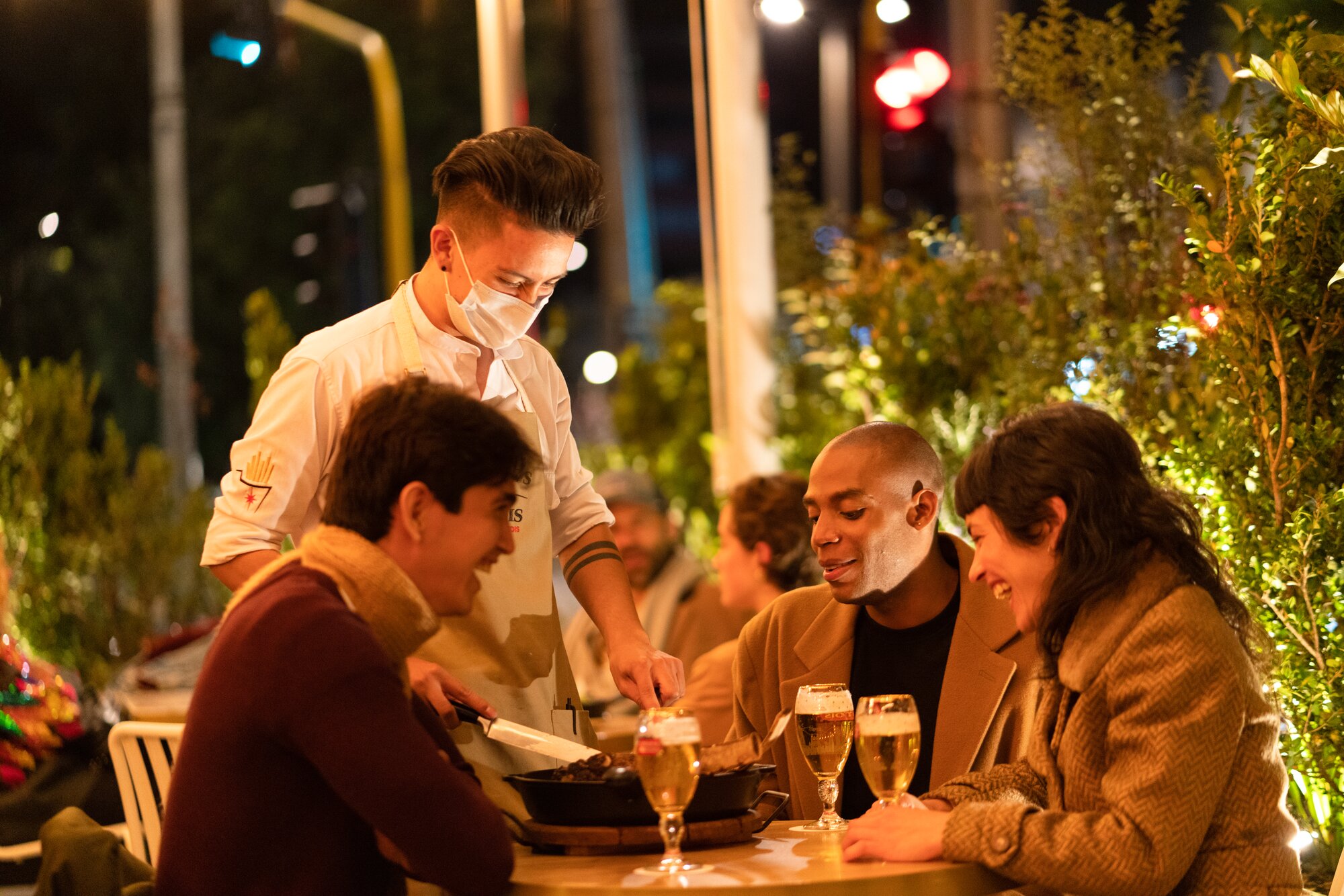 Image of Waiter and friends having
        dinner