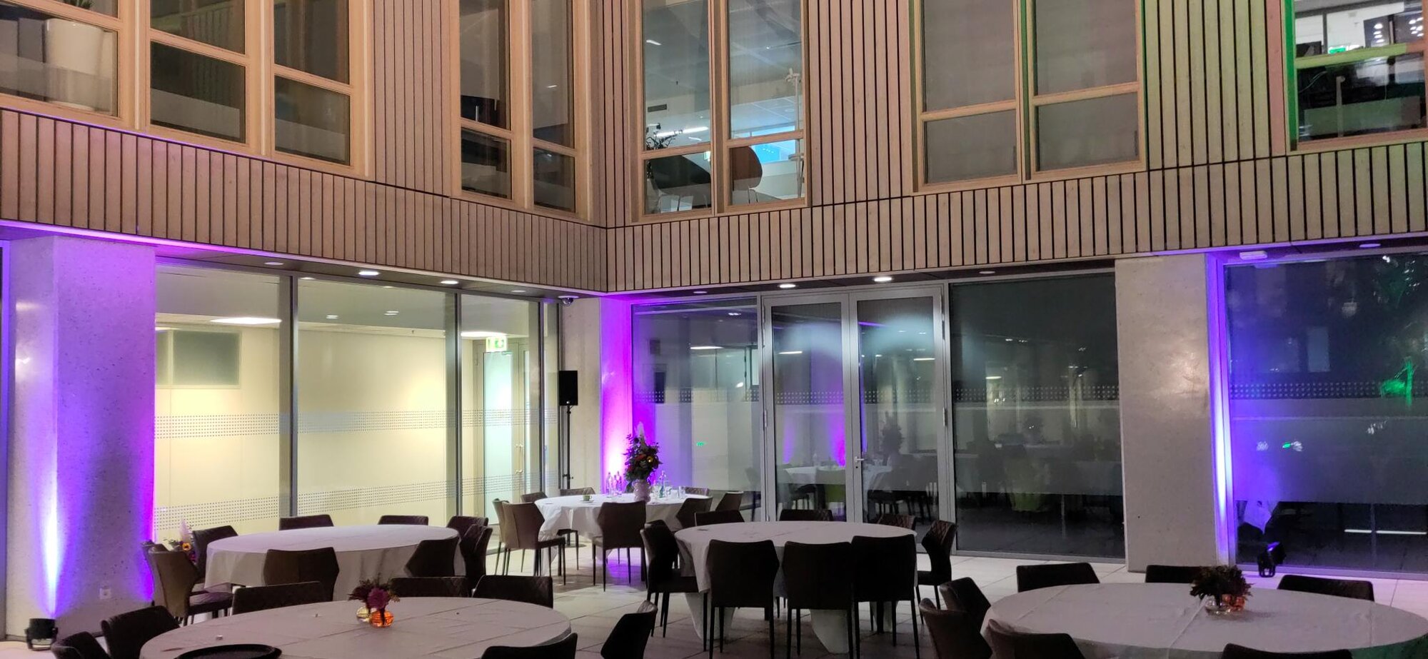 Elegant event venue with professional lighting setup and dining areas ready for events.