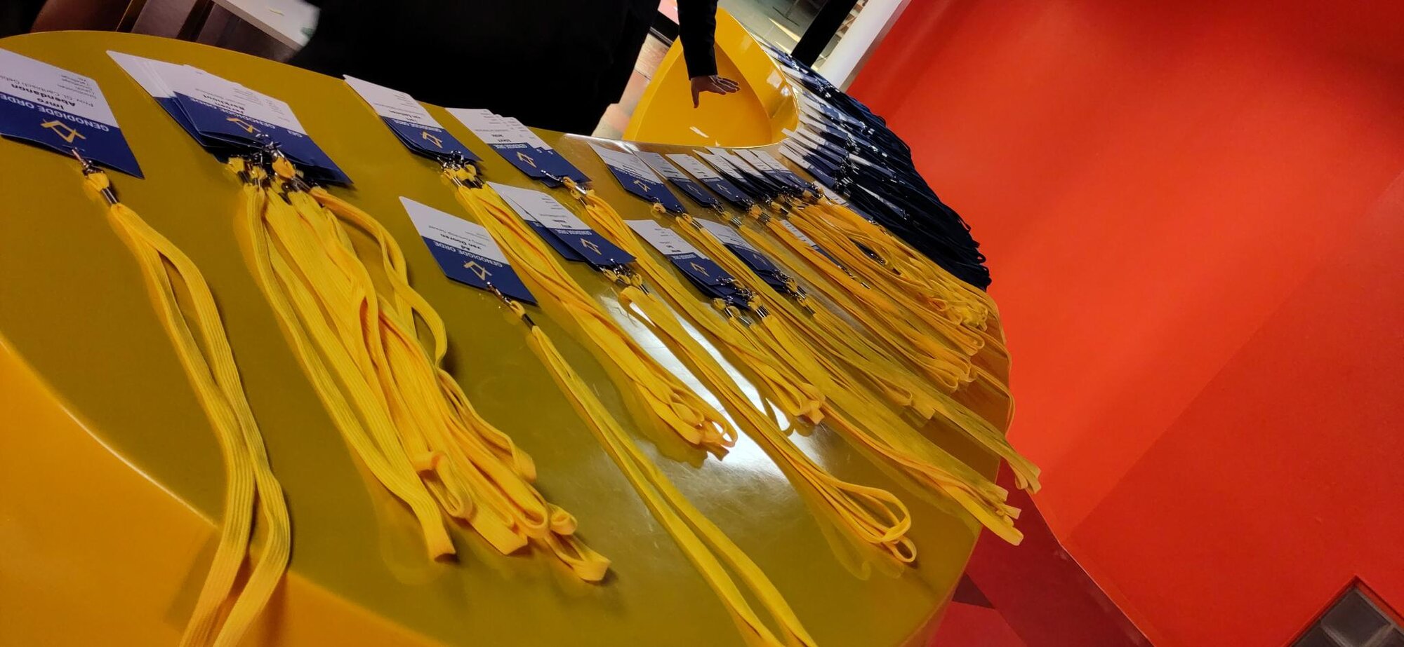 Yellow event badges laid out on a table