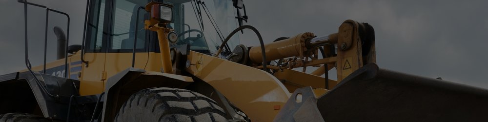 A yellow wheel loader with a bucket attachment