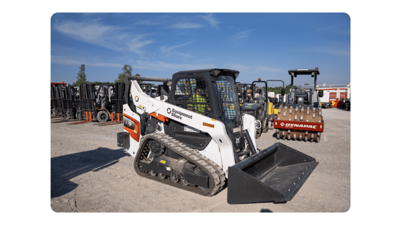 A compact track loader on an equipment yard