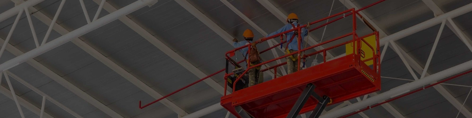 Workers on a scissor lift repairing a ceiling