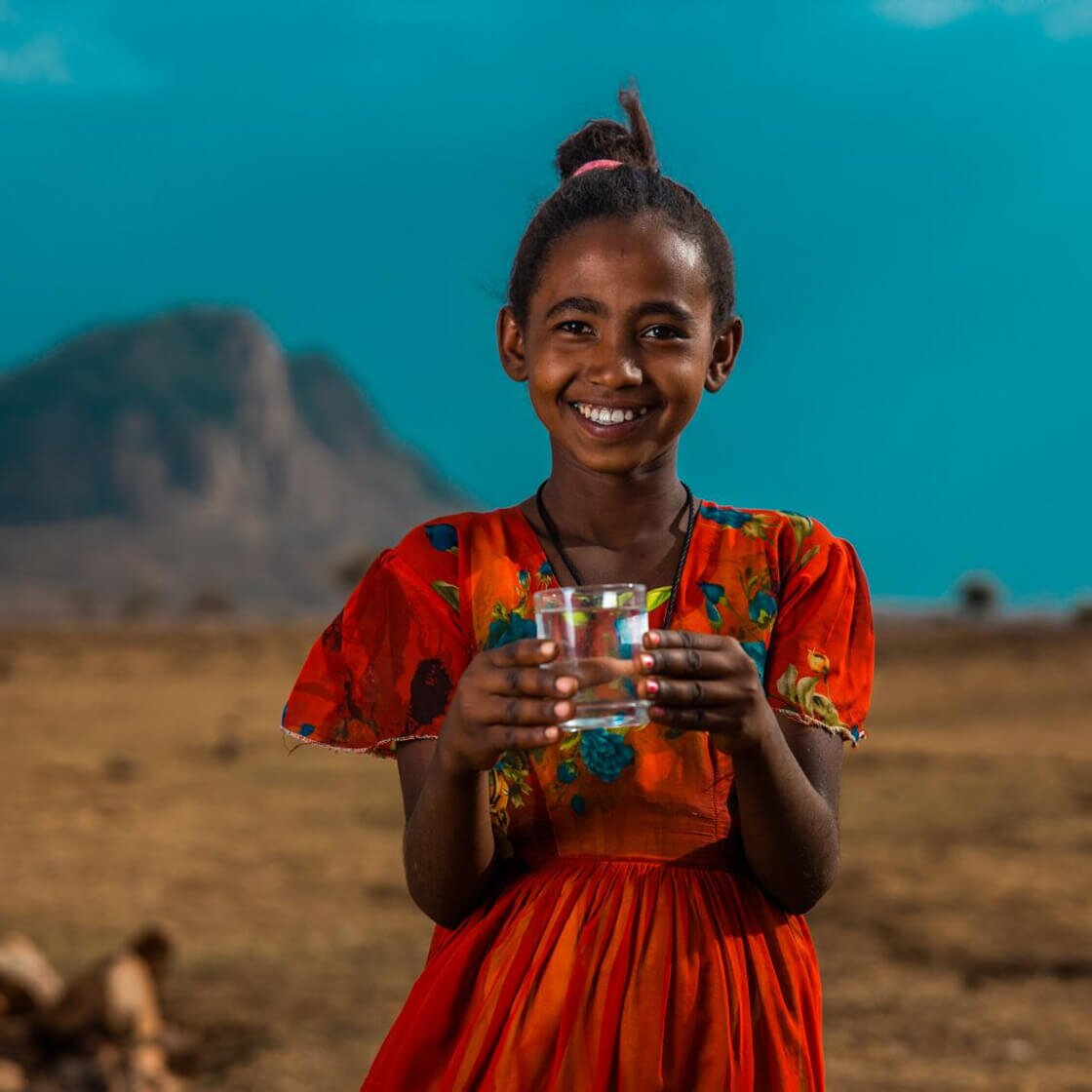 Girl with a glass of clean water