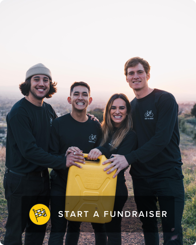 Three men and one woman stand together, each with one hand holding a single yellow jerry can.