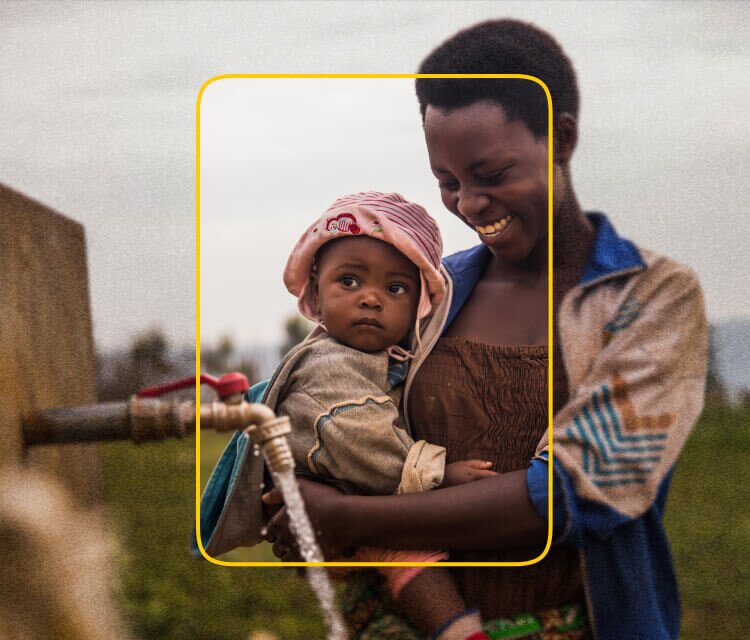 African woman and child filling a jerry can with clean, safe water from a tap