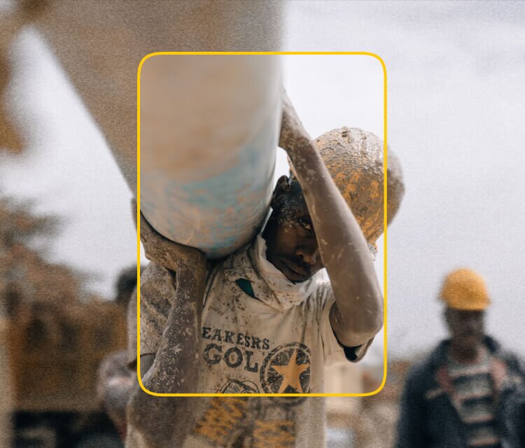 African boy carrying a water pipe