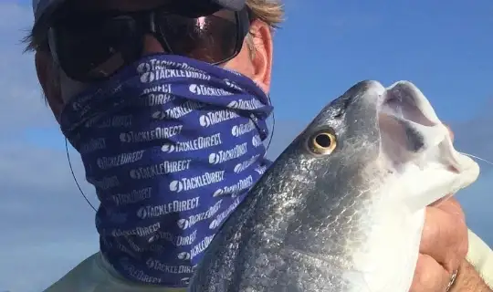 Close-up of an angler holding a fish