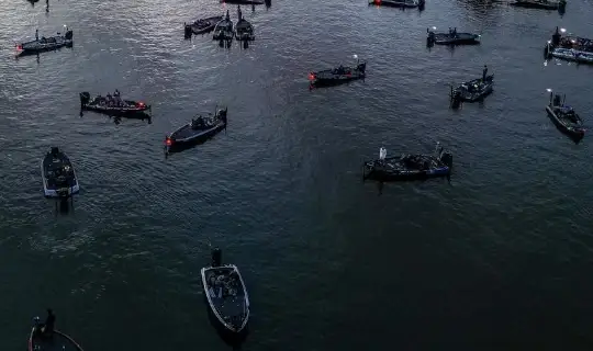 A bunch of bass boats gathering at a hot spot.