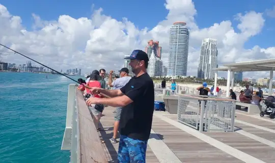 Close-up of Nick Honachefsky fishing from the Miami pier