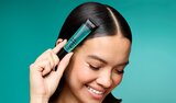 Model Using Power Grip Hair Gel Wand To Slick Back Hair