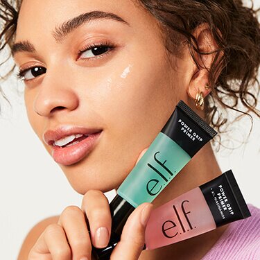 Woman holding Power Grip Primer and Power Grip Primer + 4% Niacinamide