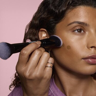 Model Applying Camo Liquid Bronzer & Contour with Makeup Brush