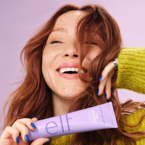 model holding lightweight hair styling cream