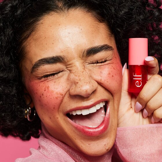Woman holding Sheer For It Blush in red