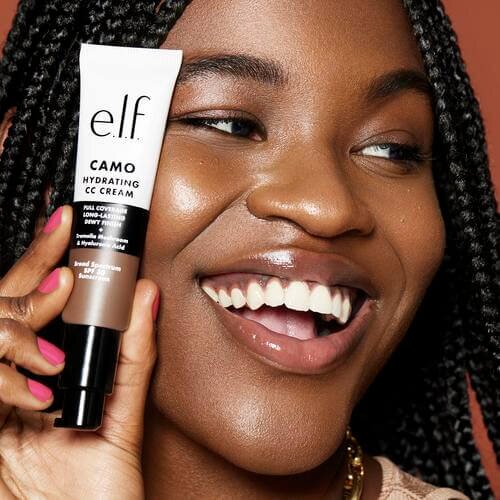 Model holding e.l.f. cosmetics hydrating cc cream