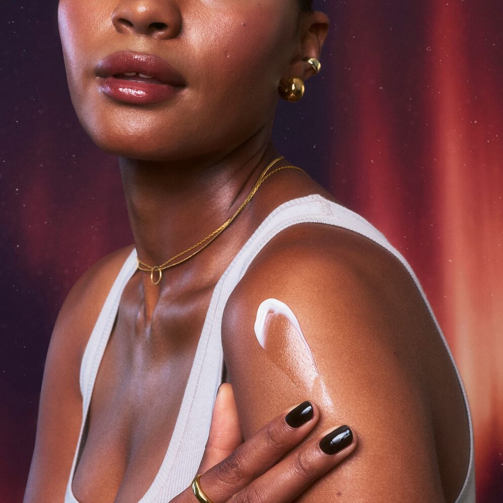 Model applying e.l.f. Spicy Bundt Nice Silky Body Cream on her skin