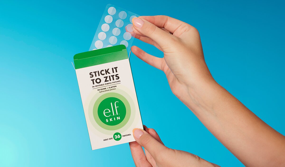 Hand holding up pimple patches