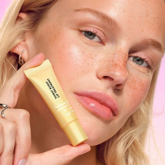 Model holding e.l.f. SKIN peptide lip treatment