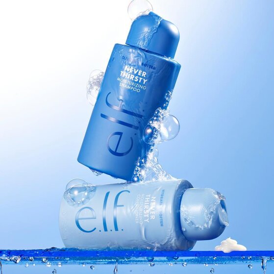 e.l.f. Never Thirsty Moisturizing Shampoo and Conditioner bottles stacked with water droplets and bubbles 