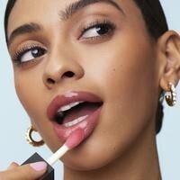 Model Applying Glow Reviver Lip Oil