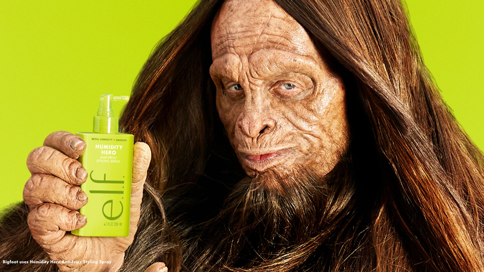 Bigfoot holding e.l.f. Humidity Hero Anti-Frizz Styling Spray