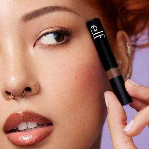 Woman holding and wearing Wow Brow Gel