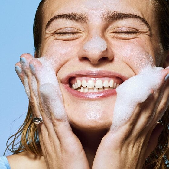 Model washing face with e.l.f. SKIN face cleanser