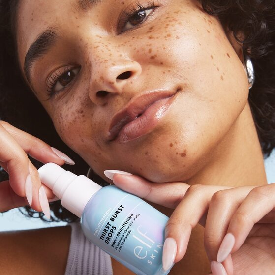 Model using e.l.f. SKIN thirst burst brightening drops
